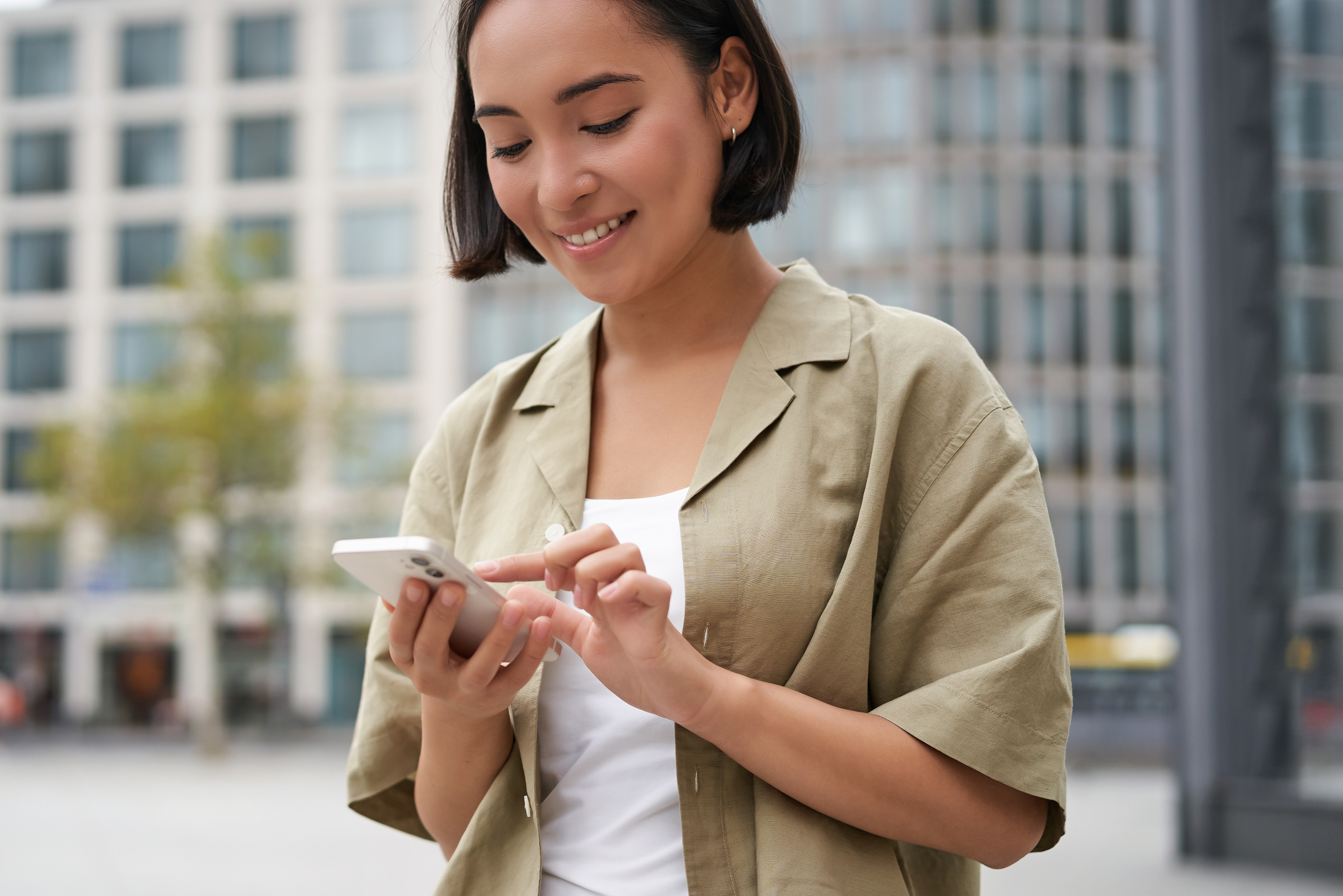 mobile-technology-smiling-asian-woman-using-smartphone-app-looking-her-telephone-street